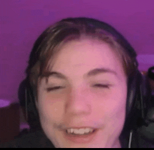 a close up of a person wearing headphones with their eyes closed and smiling .