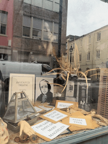 a book called invented truth sits in a window display
