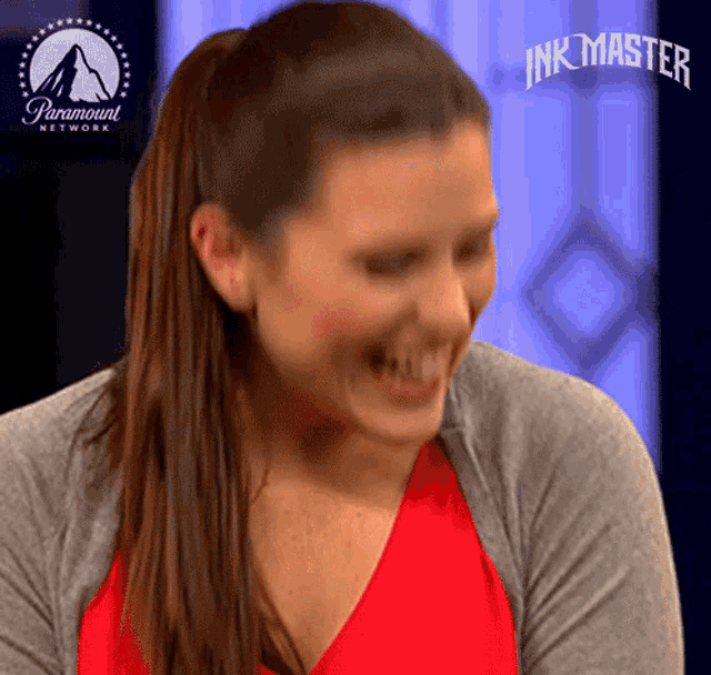 a woman is laughing with a paramount network logo in the background