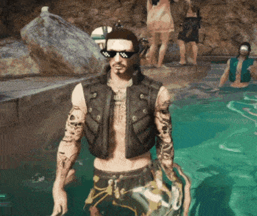 a man wearing sunglasses stands in a pool