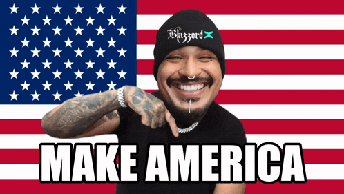 a man in front of an american flag with make america written on it