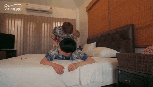 a man is laying on a bed while a woman massages him with the words our vacance written above him