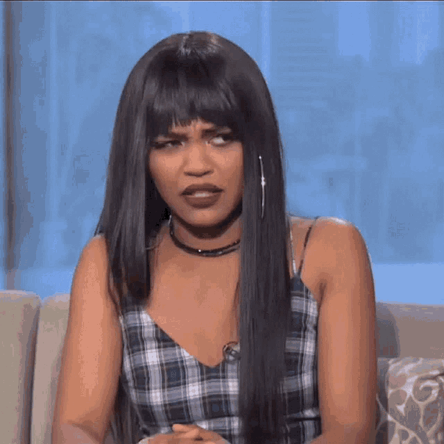 a woman sitting on a couch with her eyes closed
