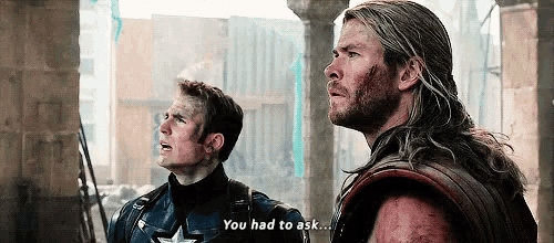 captain america and thor are standing next to each other in a movie scene .