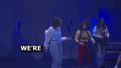 a group of people dancing in front of a banner that says keep the beans