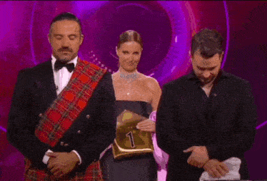 a man in a plaid kilt is holding a sign that says francisco .