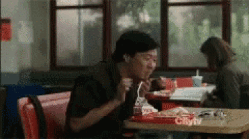 a man is sitting at a table with a tray that says city tv