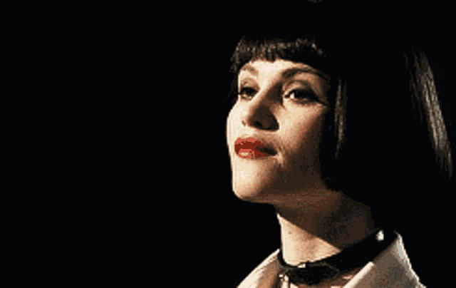 a close up of a woman 's face with red lips