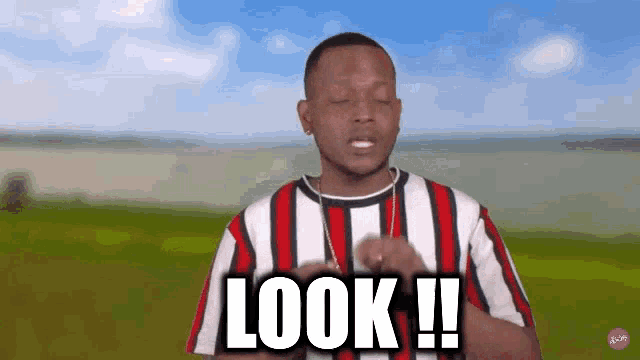 a man wearing a striped shirt says look !