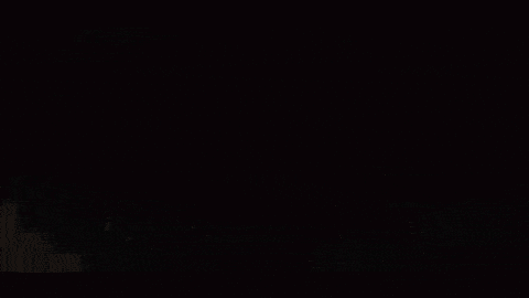 a black and white photo of a person in a dark room
