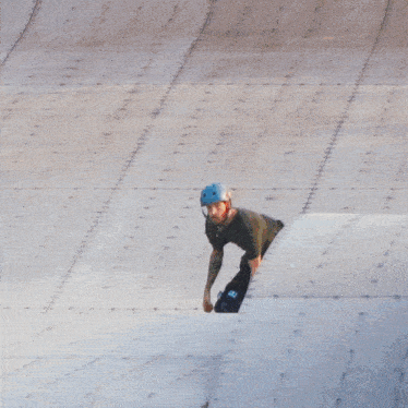a skateboarder is jumping in the air with his skateboard