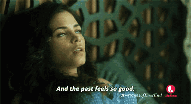 a woman laying in bed with the words " and the past feels so good "