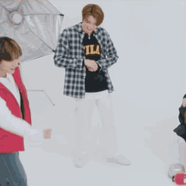 a man in a plaid shirt is dancing in front of a white background with korean writing