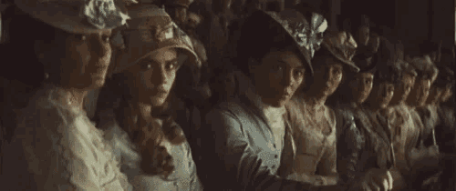 a group of women wearing hats are sitting in a row