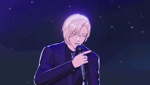 a man in a suit is holding a microphone in his hand
