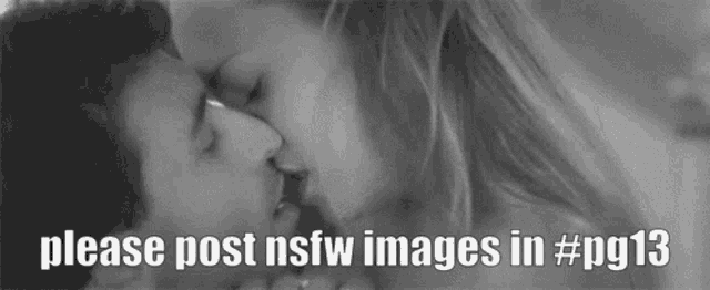 a black and white photo of a man and woman kissing