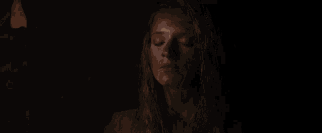a close up of a woman 's face with a blurred background