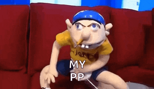 a puppet is sitting on a red couch with a pencil in his nose and says `` my pp '' .