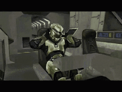 a video game character in a helmet is sitting in a chair .