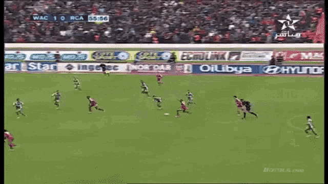 a soccer game is being played on a field with ads for oillibya and hyundai in the background