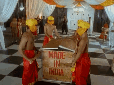 a group of men are carrying a box that says made in india on it