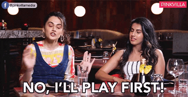 two women sitting at a table with the words no i 'll play first
