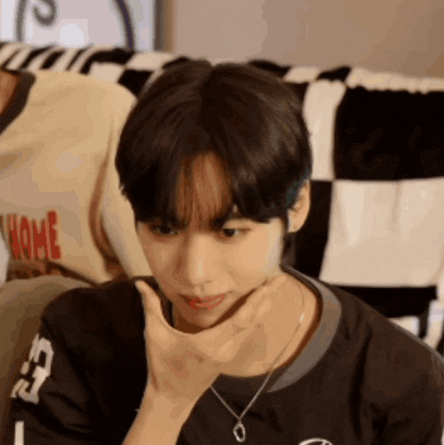 a young man wearing a black shirt with the number 13 on it