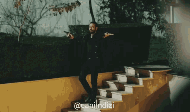 a man holding a gun is walking down stairs with the hashtag @canimdizi on the bottom