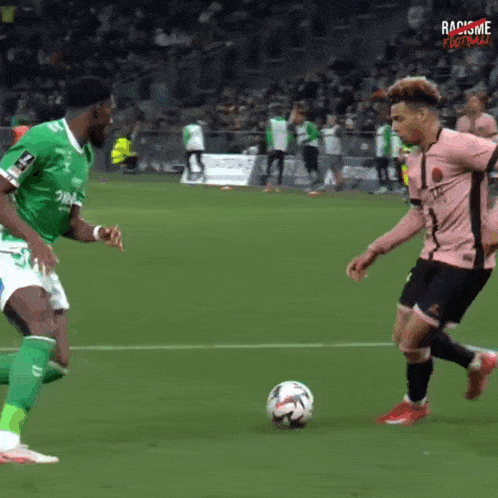 two soccer players on a field with racism football written on the bottom right