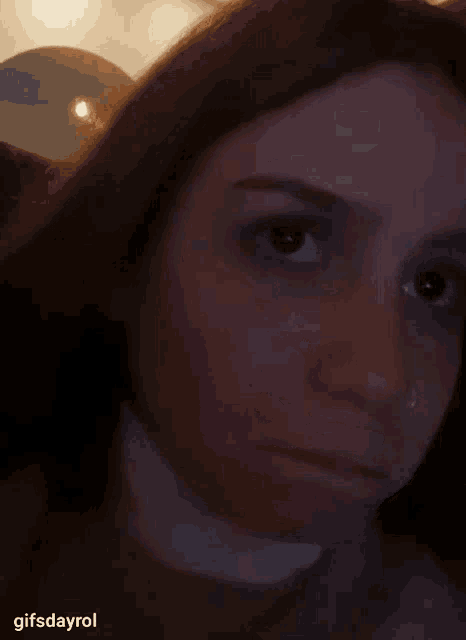 a close up of a woman 's face with the words gifsdayrol below her
