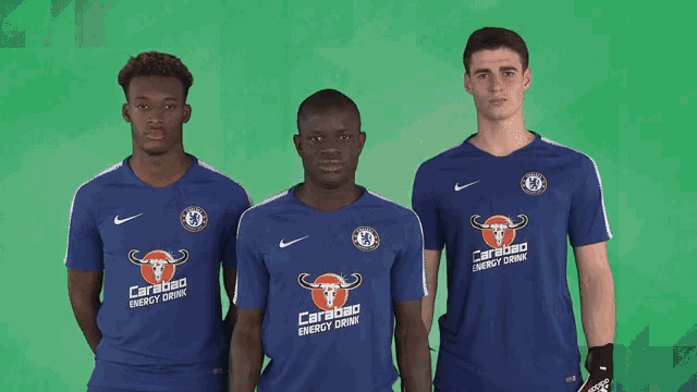 three soccer players wearing blue shirts with carabao energy drink on them