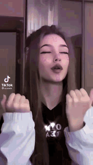 a tiktok video of a girl with a bunny on her face dancing