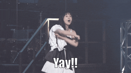 a woman with her arms outstretched and the word yay written on the bottom