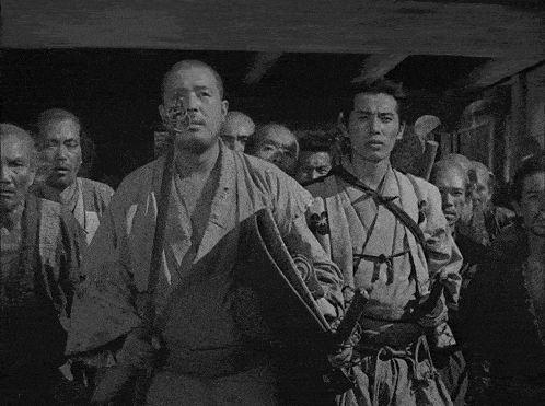a black and white photo of a group of men and women