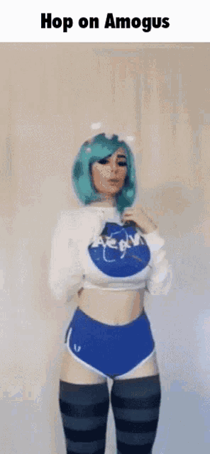 a girl with green hair is wearing a nasa shirt and blue shorts