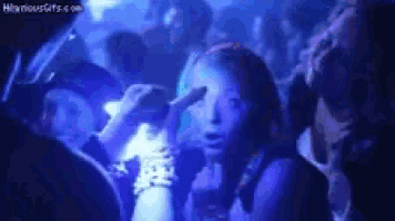 a group of people are dancing in a dark room with blue lights
