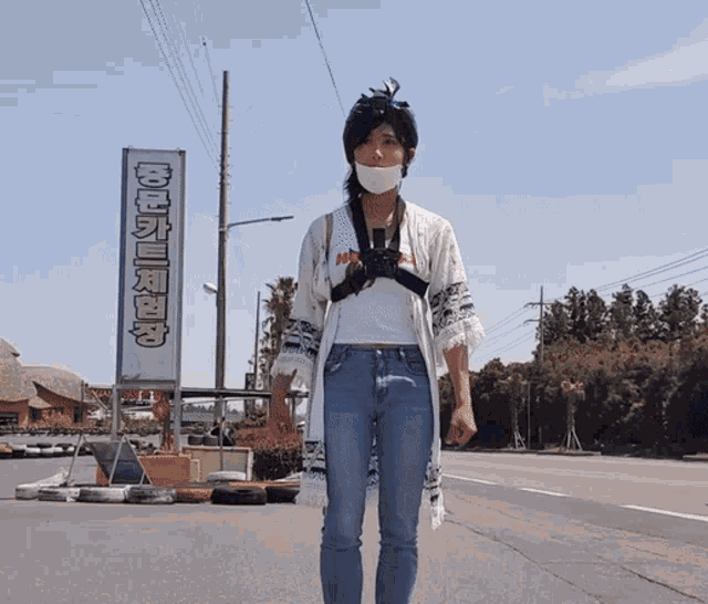 a woman wearing a white mask stands in front of a sign that says ' korean ' on it