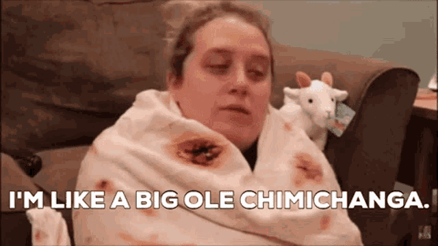 a woman is wrapped in a burrito blanket and says i 'm like a big ole chimichanga