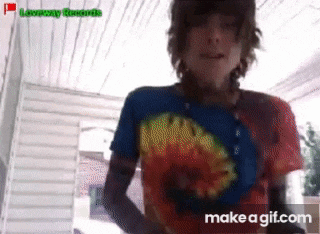 a gif of a person wearing a tie dye shirt with the words make a gif.com on the bottom right