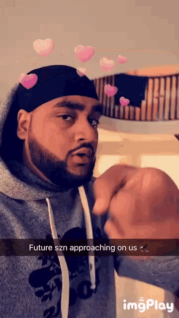 a man wearing a hoodie has a snapchat that says future szn approaching on us ..