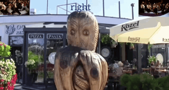 an owl statue in front of a pizza pasta restaurant
