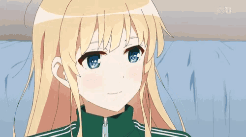 a girl with blonde hair and blue eyes is wearing a green jacket .