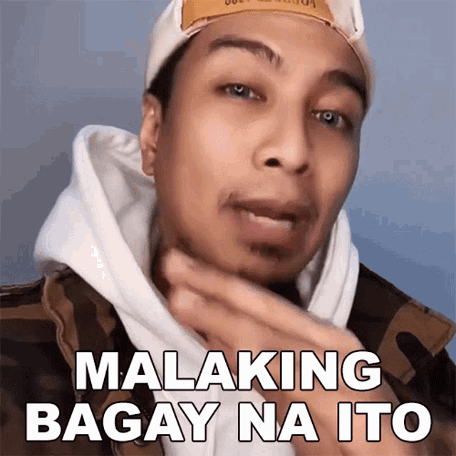a man wearing a hat says malaking bagay na ito on his face