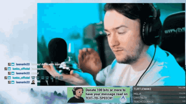 a man wearing headphones is sitting in front of a screen that says turtlewake on it