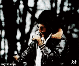 a man singing into a microphone with imgflip.com in the lower right corner