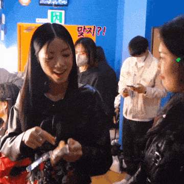 a group of people are standing in a room with a sign that says ' exit '