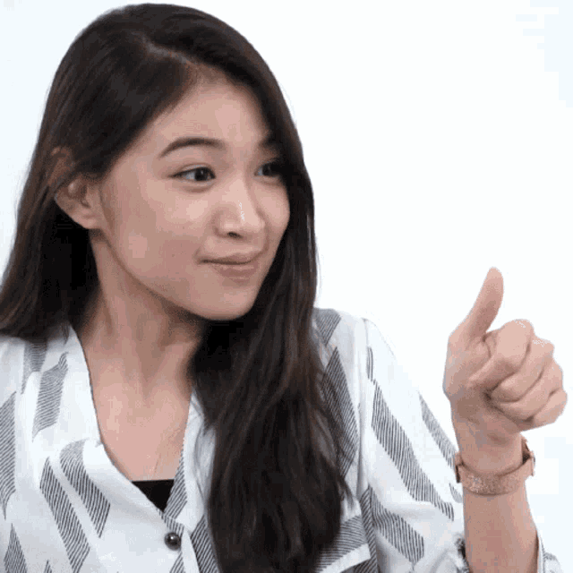 a woman giving a thumbs up sign with her hand