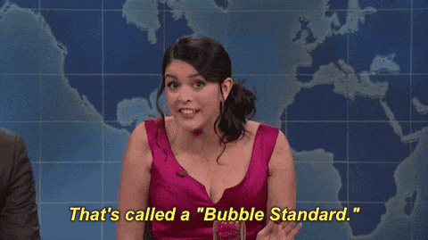 a woman in a pink dress is saying that 's called a " bubble standard "