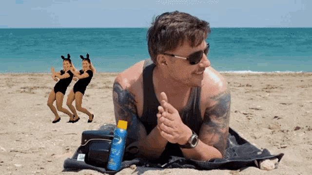 a man laying on a beach with a bottle of sunscreen