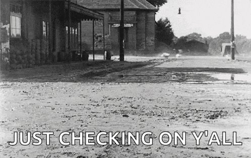 a black and white photo of a dirt road with the words just checking on y'all